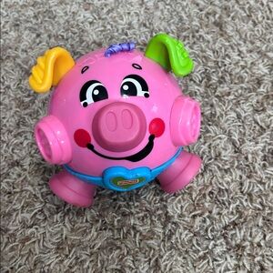Fisher-Price Brilliant Basics Bounce & Giggle Pig toy.